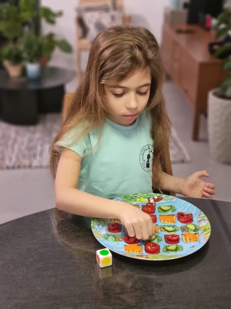 Ori eating and playing on the Playte game plate